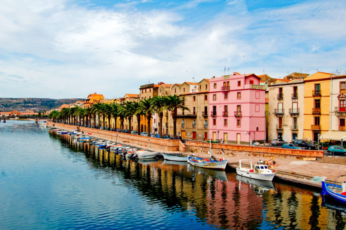 Street with palm trees along the coast in bosa, sardegna